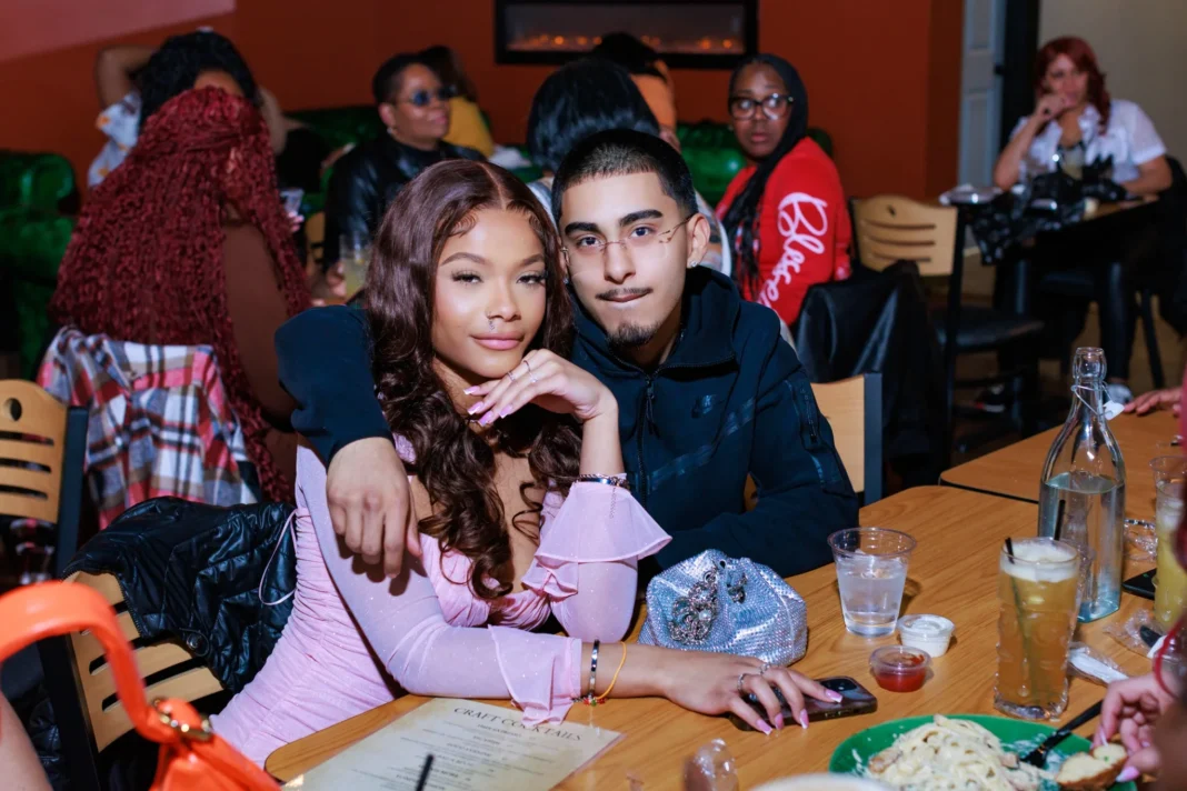 A couple enjoying a fun night at Minnie’s during Karaoke Sunday, surrounded by a lively restaurant atmosphere.